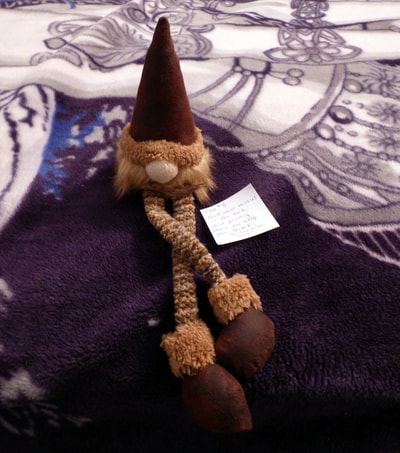 gnome plush and clue #3, on guest bed